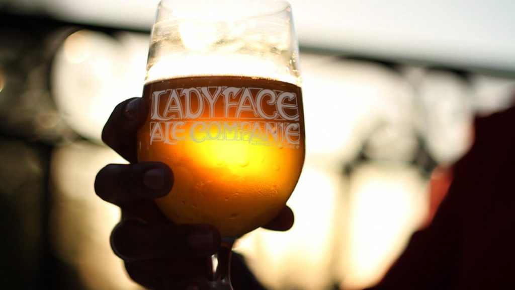 Sipping a glass of Ladyface ale at sunset on the patio